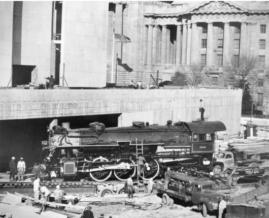 B&W photo of train being installed