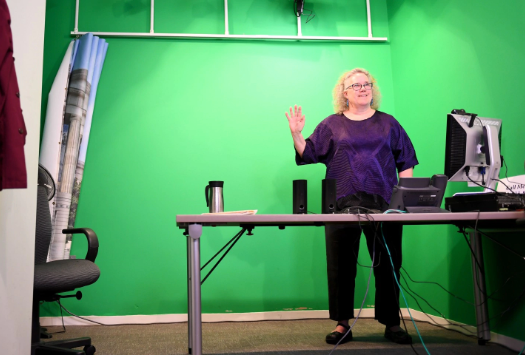 Instructor in front of green screen