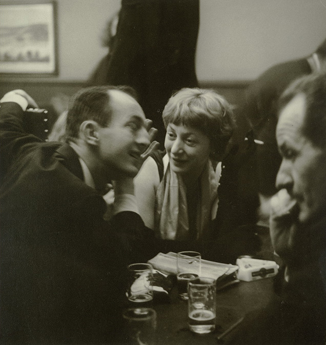 Snapshot of three people smoking and talking