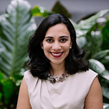 Portrait of urena in front of foliage wearing pastel dress