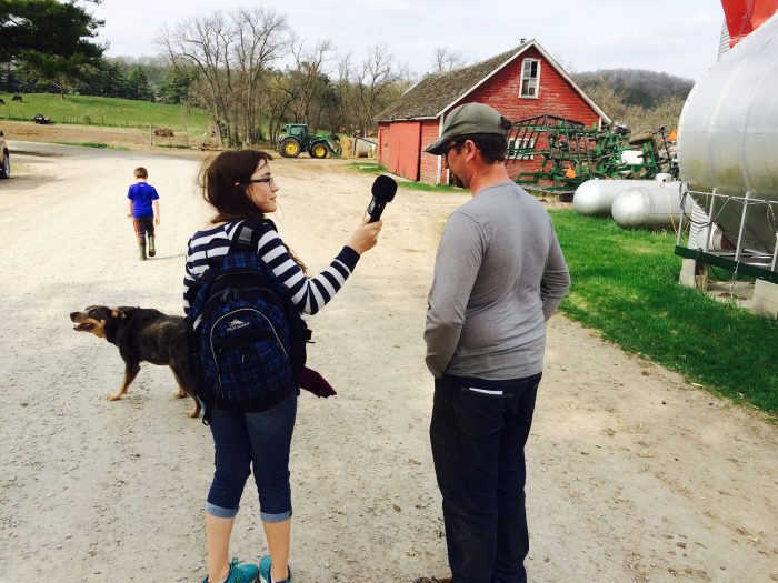 Student interviewing farmer