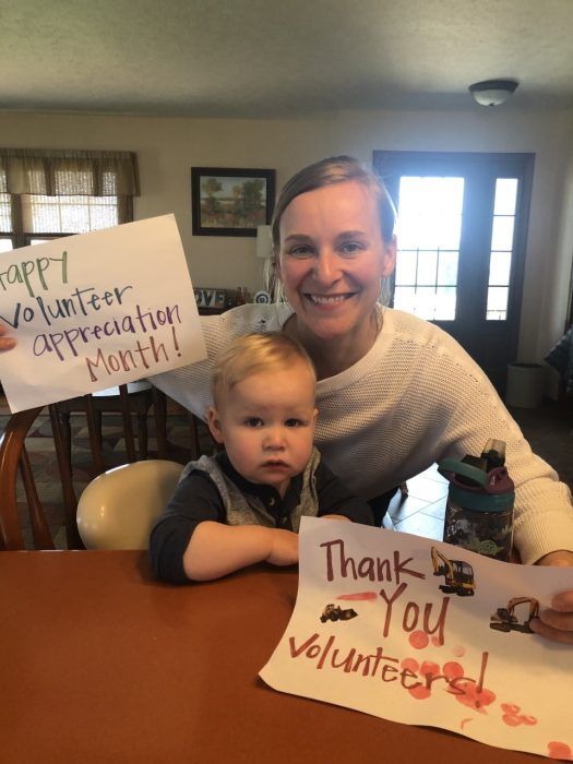Abbey Earich and son with thank you signs