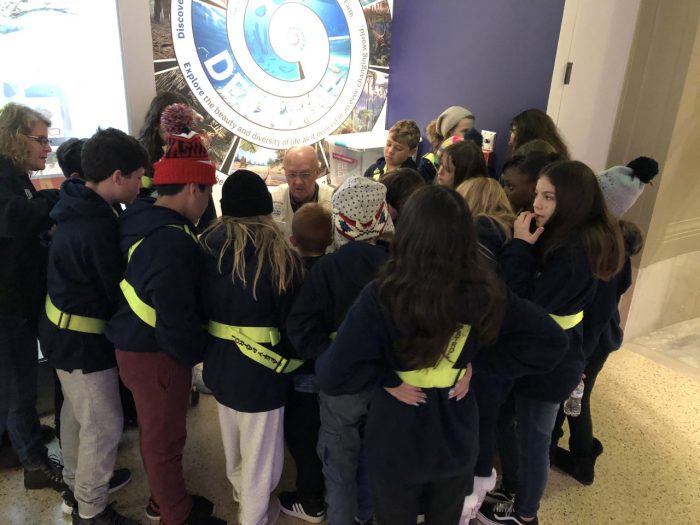 Dan Roe surrounded by a group of students