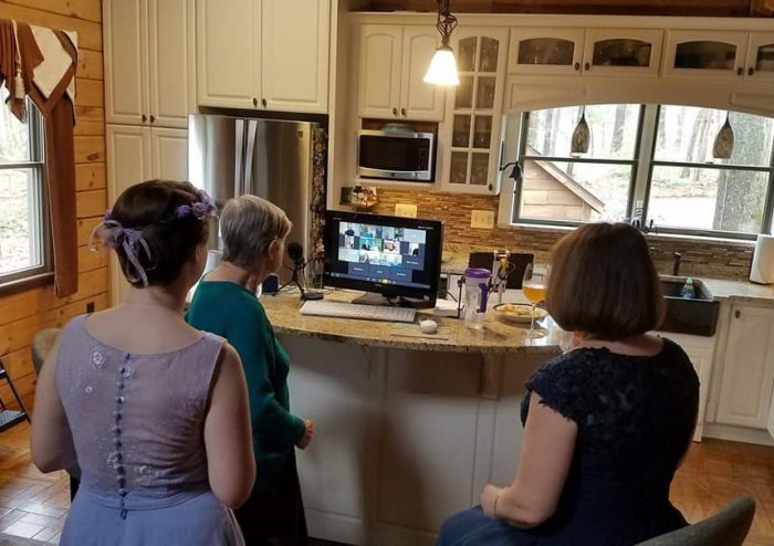 Three women watching a laptop