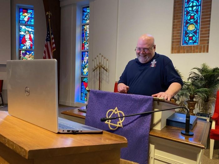 Pastor in pulpit with laptop