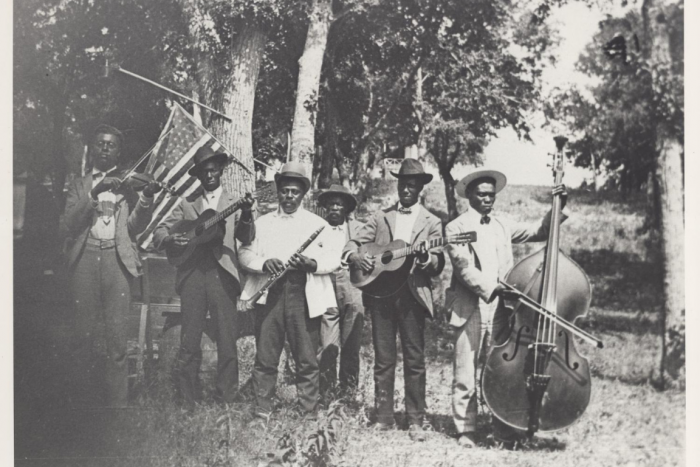 Men holding instruments and flags
