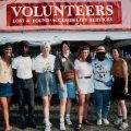 Group of volunteers pose at Lost & Found tent