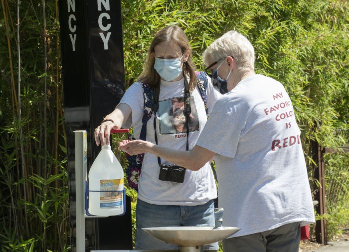 Guests using sanitizing station