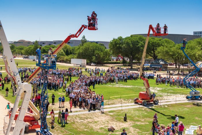 Cherry pickers overlooking gathering crowd