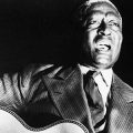 Cropped photo of Lead Belly in performance