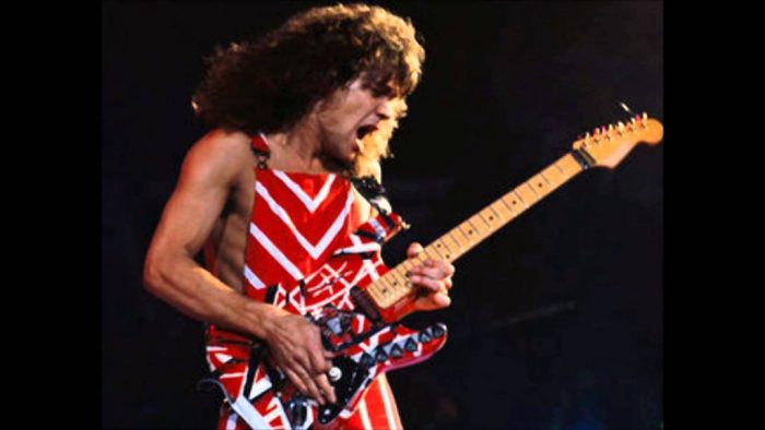 Van Halen in red and white outfit with read and white guitar
