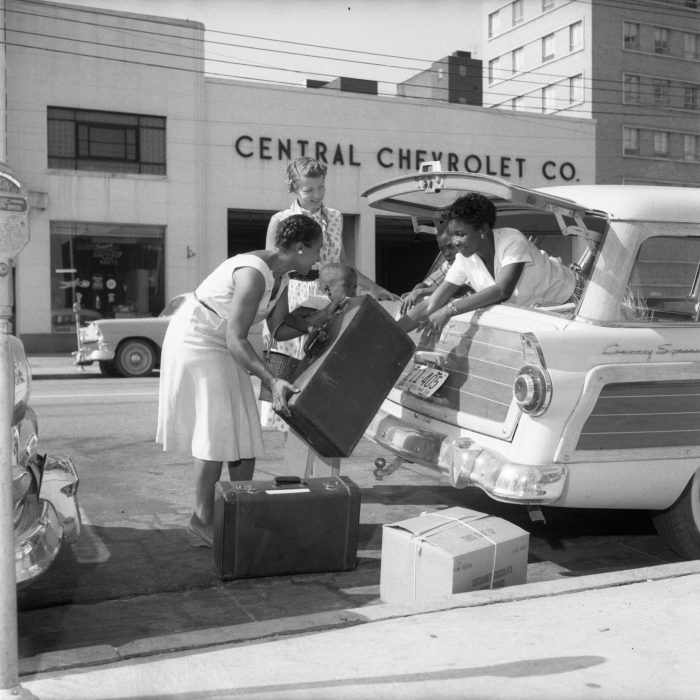 Two women loading station wagon
