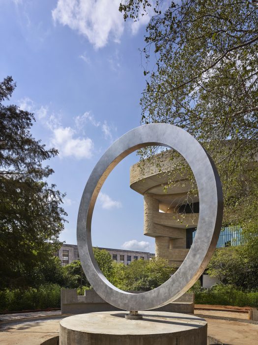 Close view of Native American Veterans Memorial, a polished steel circle mounted on stone dais