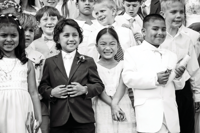 Black and white photo of smiling multiracial school children