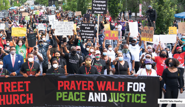 Crowd holding Prayer Walk banner