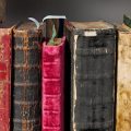 Old books lined up on a shelf