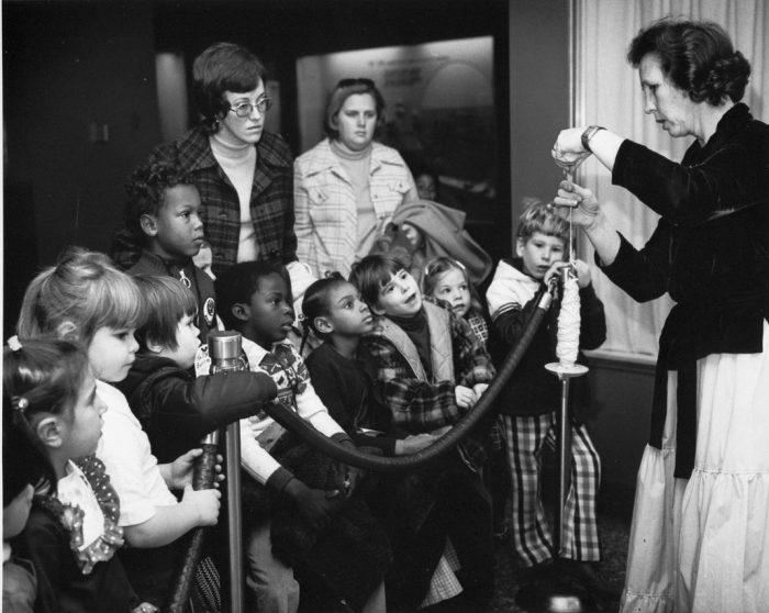 Black and white photo of children with docent