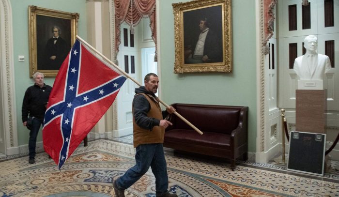 Man carrying Confederal Flag inside Capitol