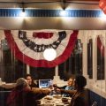 Four people at restaurant table with bunting