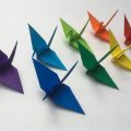 Eight origami cranes in various colors
