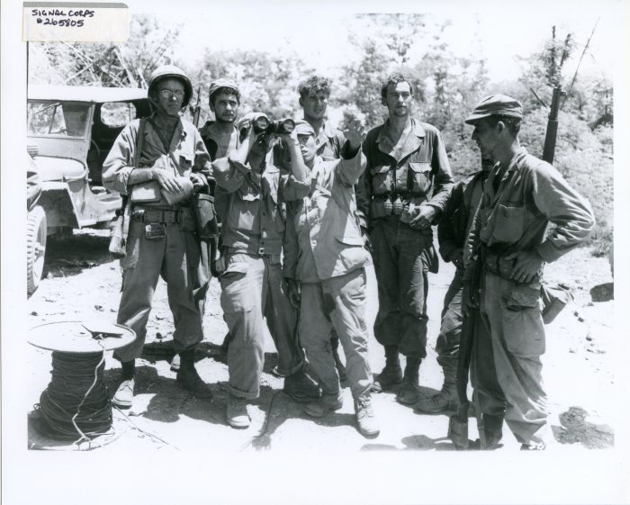 Black and white photo of soldiers with captured prisoner