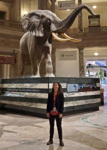 Osborne poses in front of Henry the elephant in NMNH rotunda