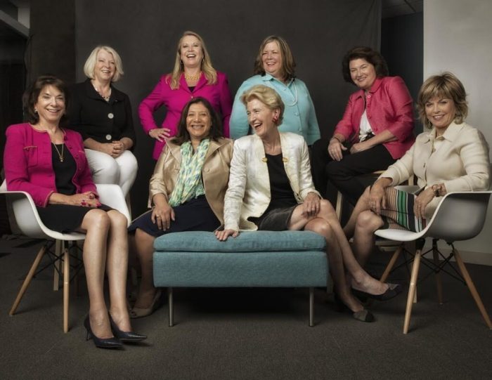 Group photo of women, several wearing pink