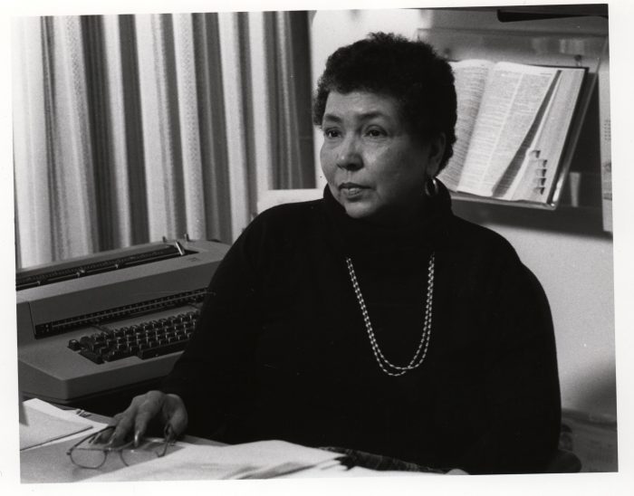 Black and White photo of Louis Hutchinson at her desk