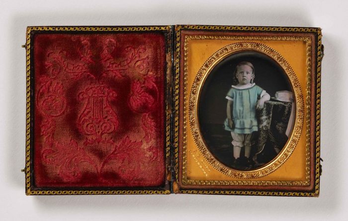 portrait of child in red velvet case