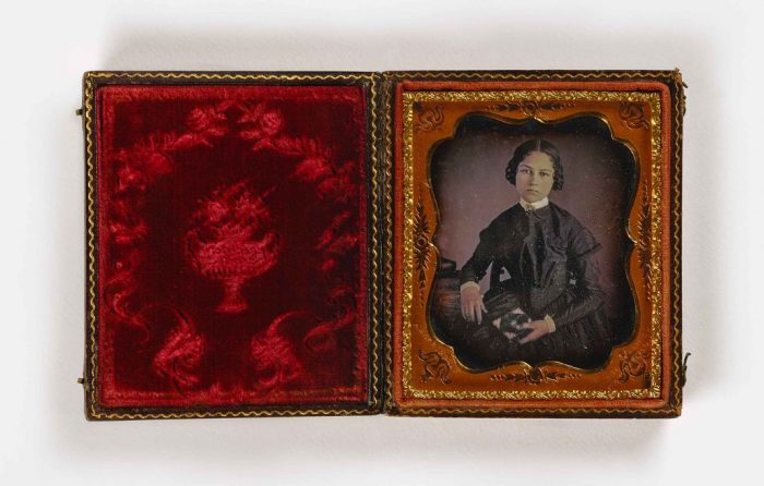 Portrait of young woman in red velvet case