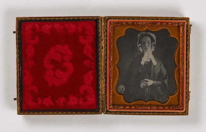 Portrait of woman in red velvet case