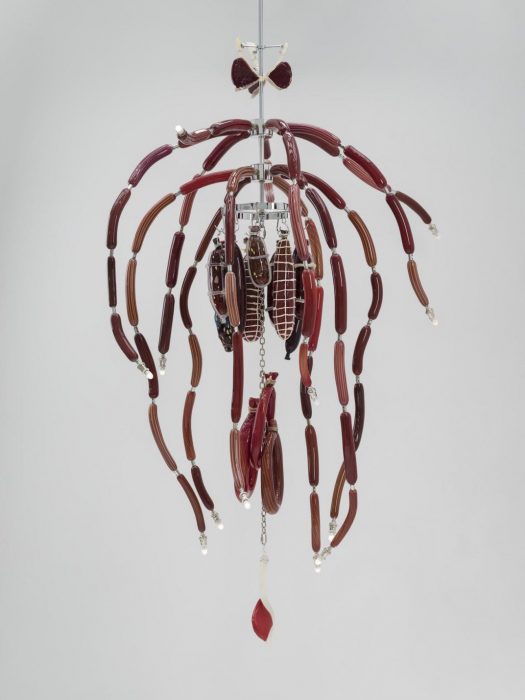 Brown glass sculpture that looks like hanging meat