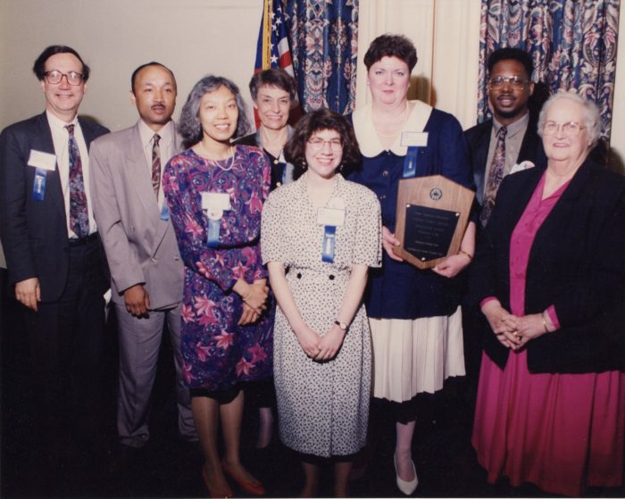 102. VIARC received a Public Service Recognition Award in May 1993. Attending the breakfast reception were (L-R) Marc Pachter (from the Secretary's Office) with VIARC staff Andre Henderson, Wendy Lim, volunteer Beverly Hariott, Susan Weidman, director Mary Grace Potter holding plaque, John Morse, and volunteer Betty Youssef.