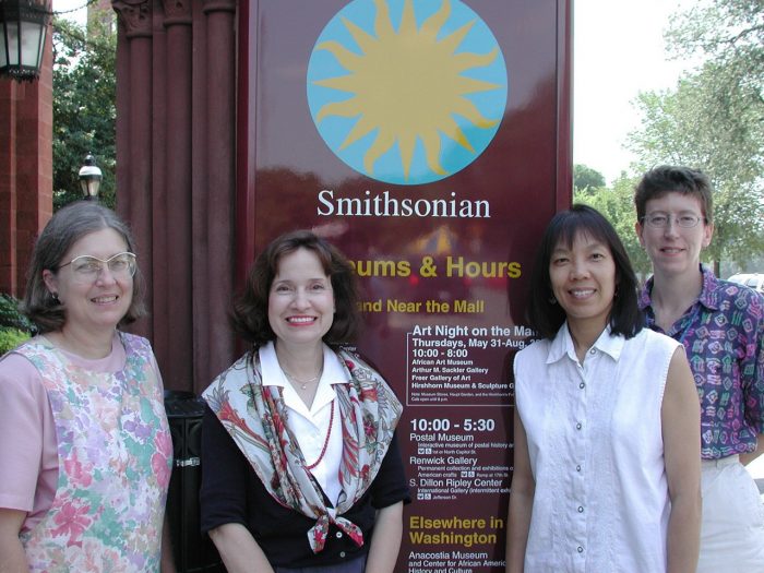106. Left to Right: Kathleen Brooks, Information Resources Division (IRD) Manager, Jane Gardner, Wendy Lim, and Bridget Balog in front of Info Center pylon, 2001