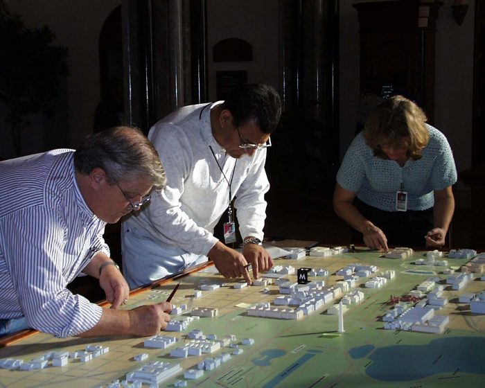 Dick Kilday, Rolando Mayen, Paula Kaufman working on the 3-D federal city map model display in the Castle's Great Hall in April 2000. Photo taken by VIARC-IRD's writer/editor Wendy Lim.