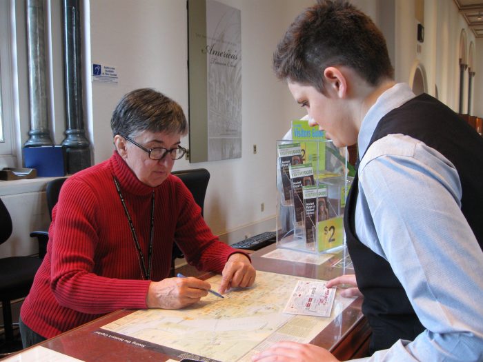 Volunteer Vivian Van Horne shows Jocelyn Joudrey locations of various Smithsonian museums at the Smithsonian Information Center in the Castle.