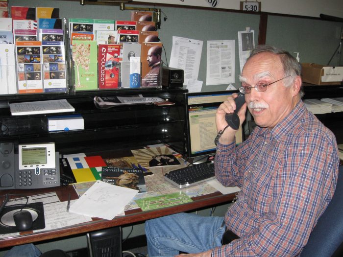 Volunteer Wendall Morris answers calls in Telephone Services in the Smithsonian Castle.