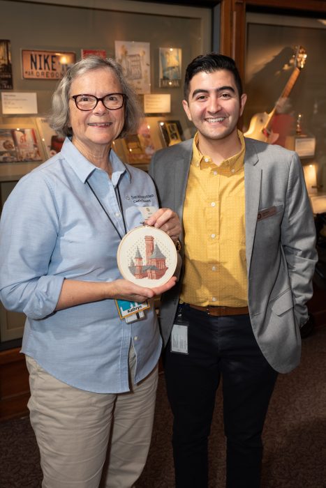 Volunteer with Chad Rabago and his cross-stitch prize - Castle Tea & Trivia Event - 2019