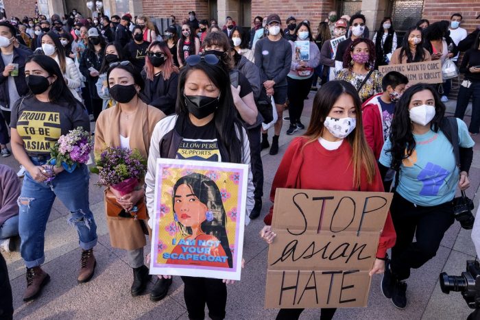 Asian protesters with signs "Stop Asian Hate"