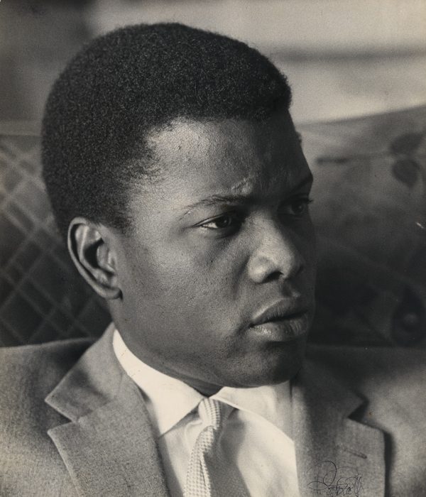 Black and white candid photo of actor Poitier in semi-profile