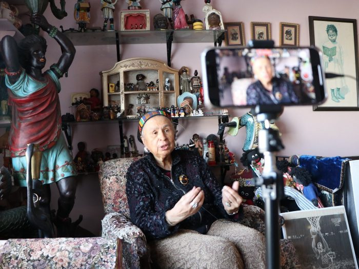 Elizabeth Meaders sits surrounded my memorabilia