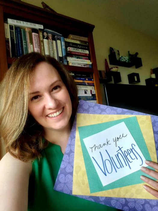 Alexis Miller holding "Thank You Volunteers" poster