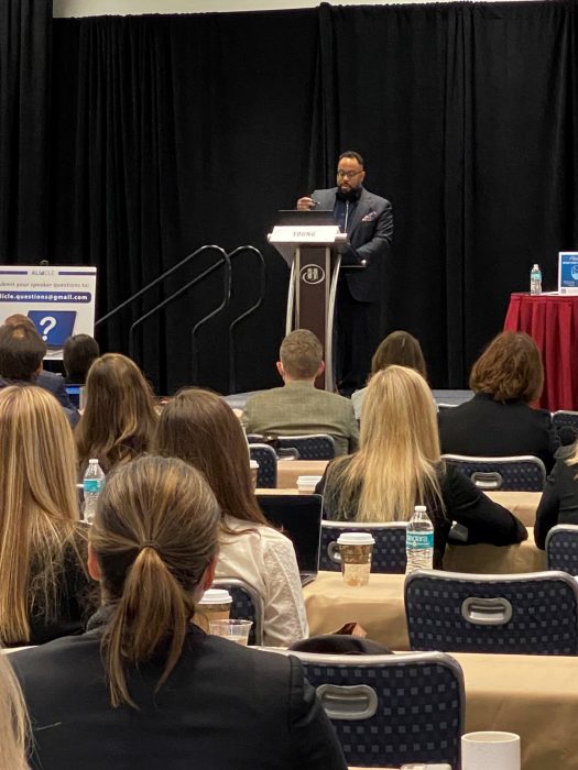 Kevin Young at podium addresses conference attendees