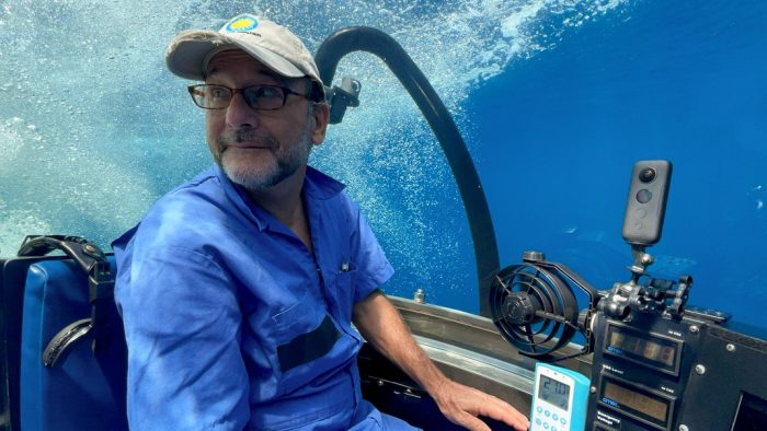 Man wearing Smithsonian cap pilots DeepSee submarine