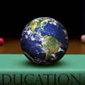 Globe sits atop book labeled "Education"