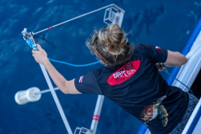 Marta Cambra leans off side of boat