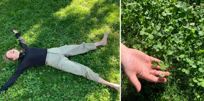 Woman lies on her back in green clover lawn 