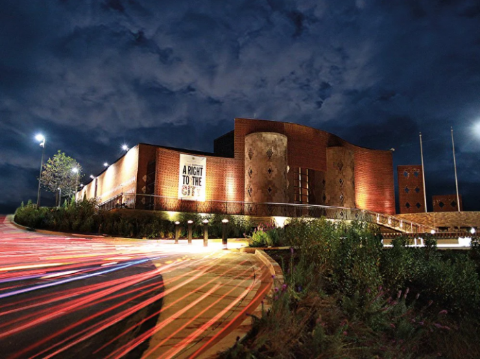 Time lapse photo of ACM at night with car light trails