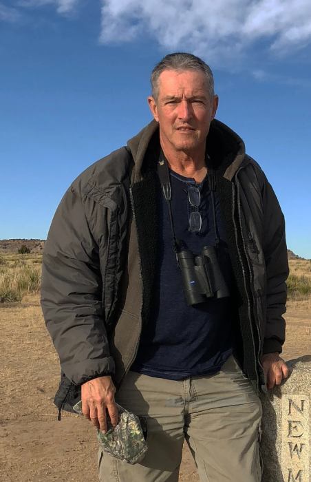 Gary Graves outdoors with barren landscape in background