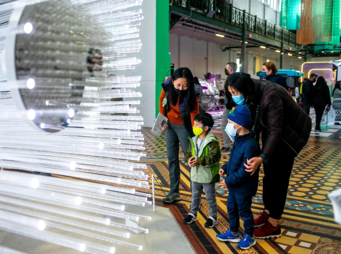 Two women with young children at the AIB Futures exhibition